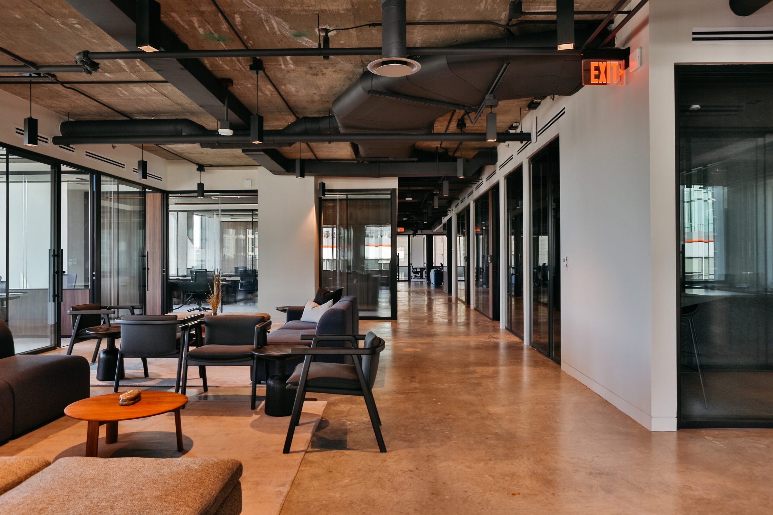 a beautifully appointed coworking space with modern decor, open space, natural light, and more