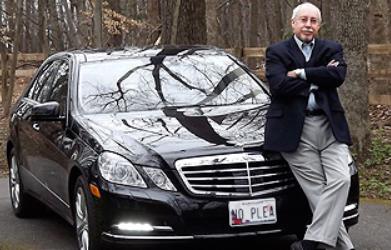 Gary S. Bernstein leaning against a car