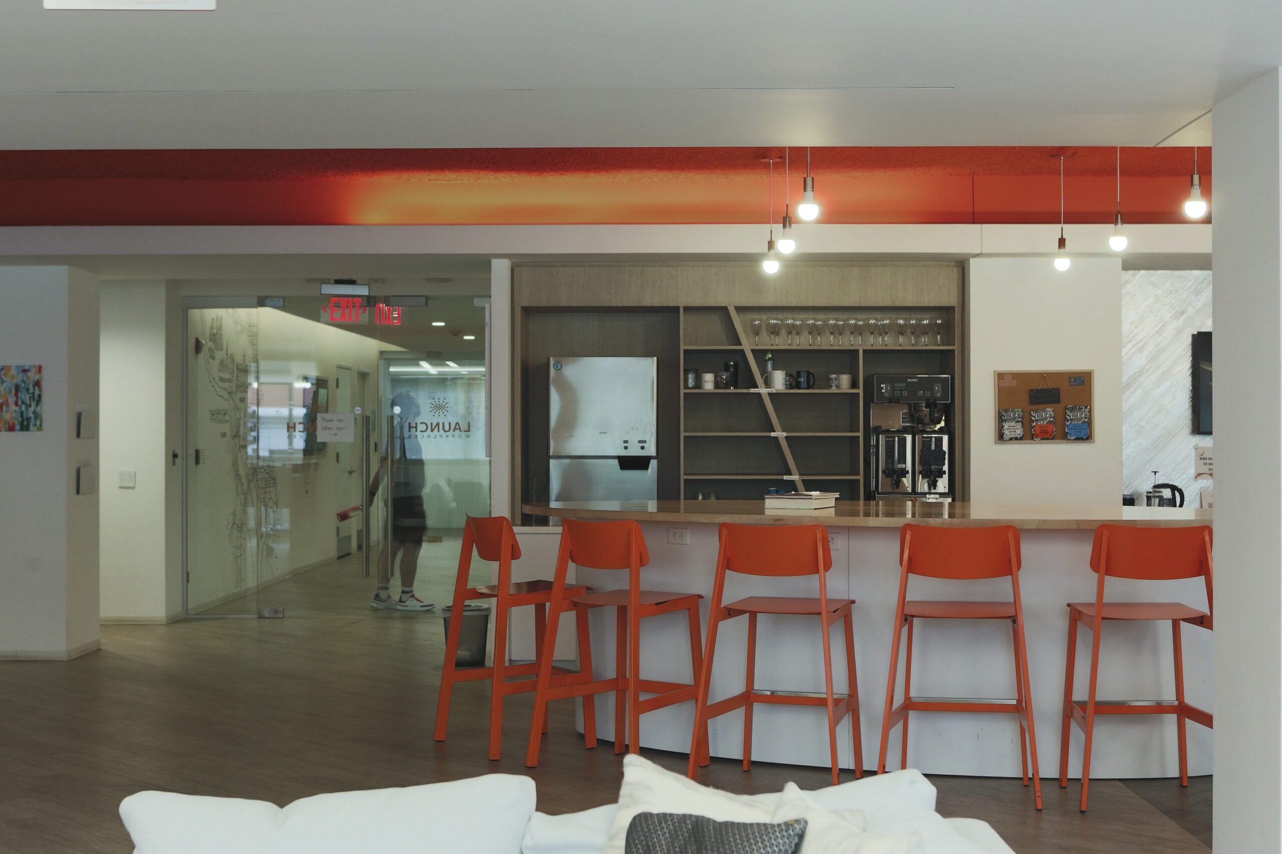 a communal kitchen inside a serviced office suites with chairs and coffee