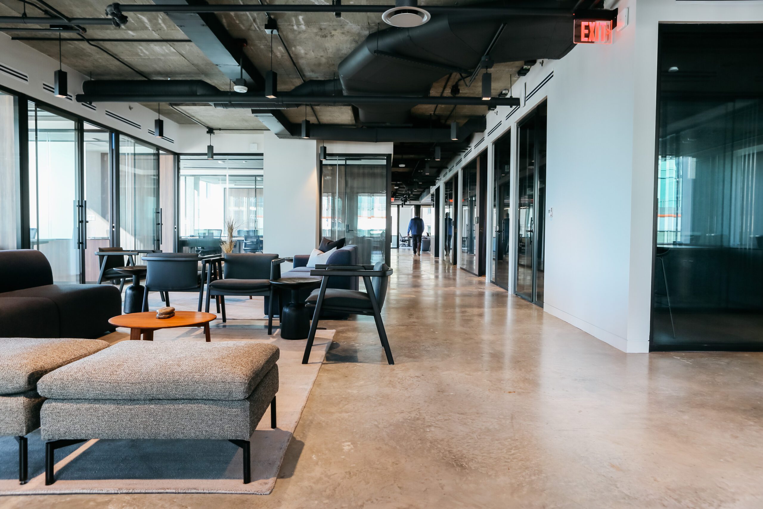 a photo of a beautiful modern coworking space with open areas and offices for office leasing